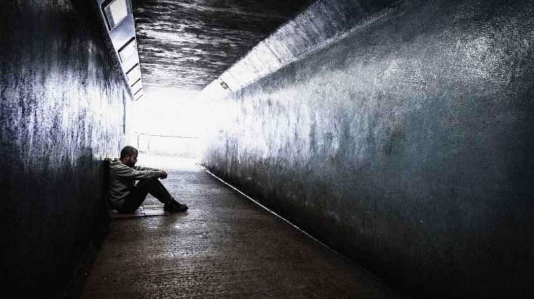 Man sitting in tunnel